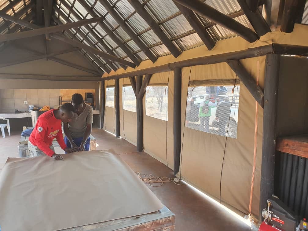 Workshop team installing canvas at lapa site